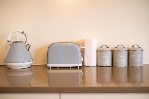a counter with a toaster and rolls of paper towels at Host & Stay - Brunswick Sea View in Brighton & Hove