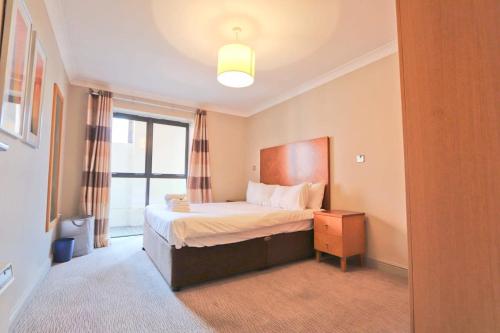 a hotel room with a bed and a window at City Centre 1 Bed Apartment in Bristol