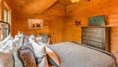 a bedroom with a bed and a dresser and a television at Memory Maker in Blue Ridge
