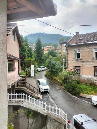 a car parked in a parking lot next to a street at Exotic Nature Hostel in Sarajevo