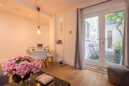 a living room with a table and a large sliding glass door at Host & Stay - Osbourne Rest in Brighton & Hove