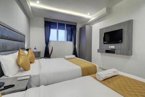 Ένα ή περισσότερα κρεβάτια σε δωμάτιο στο Hotel Isra International, BKC