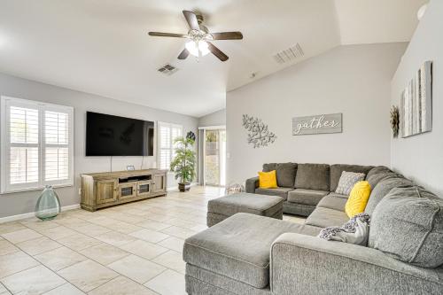 a living room with a couch and a flat screen tv at Tucson Home with Patio, Grill and Mountain Views! in Tucson