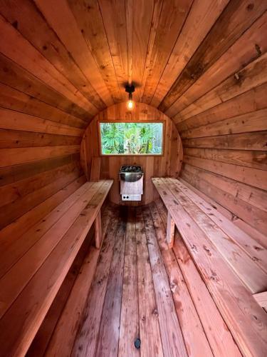an inside view of a wooden sauna with benches at Akule Clubhouse- Awa 1 Bedroom Apt by the Beach condo in Waialua