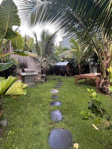 a garden with stepping stones on the grass at Akule Clubhouse- Awa 1 Bedroom Apt by the Beach condo in Waialua