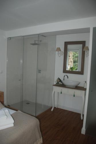 a bathroom with a glass shower and a sink at Sintra Center Guest House Escape to Nature in Sintra