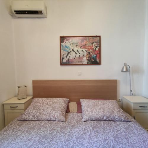 a bedroom with a bed and a picture on the wall at Cozy City Apartment - sleeps 2 in Rhodes Town
