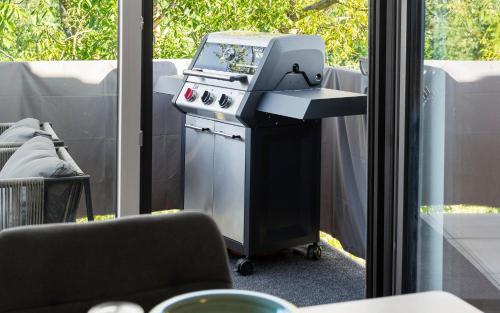 a machine sitting on a table next to a window at Lit Living Deluxe Apartments Wörth - Parking - Box Spring - BBQ - Balcony in Wörth am Rhein