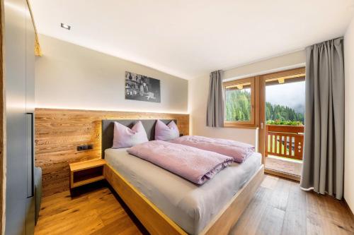a bedroom with a bed and a large window at Oberhaushof in Santa Valburga St. Walburg