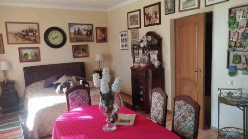 a bedroom with a bed and a table with a vase of flowers at Jumpravas pils in Jumprava