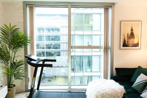 a living room with a view of a large window at Cozy Haven Flat in Milton Keynes