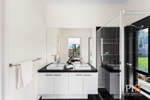 a bathroom with two sinks and a large mirror at Recently build 4BDR Family Home in Quiet Estate in Cowes