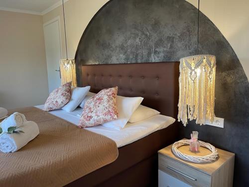 a bedroom with two beds with pillows at Villa De La Vita Alykes in Katastárion