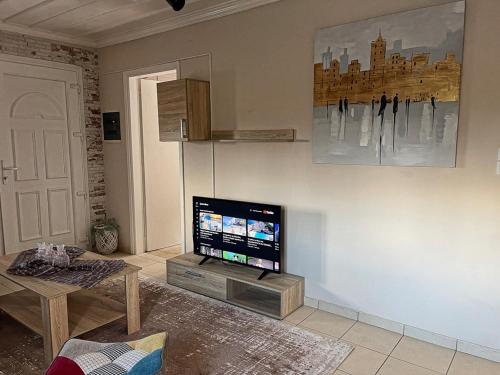 a living room with a flat screen tv on a wall at Villa De La Vita Alykes in Katastárion