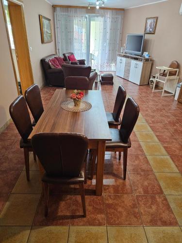 a living room with a wooden table and chairs at Apartmani Royal Residence in Golubac