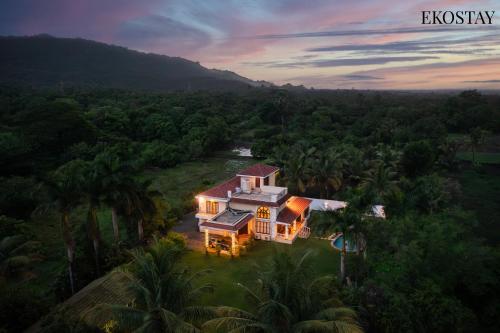 an aerial view of a house in the jungle at EKOSTAY - Casa Amado in Alibaug