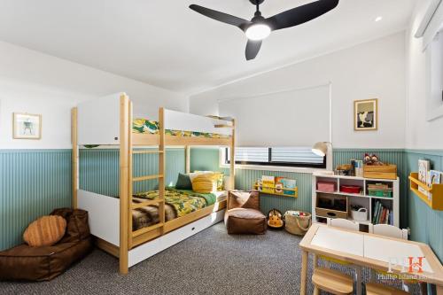 a room with two bunk beds and a table at Dream Vacation Home 3 Bdr 2 Ba in Cape Woolamai