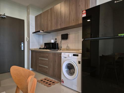 a kitchen with a washing machine in a kitchen at Central Park Cozy Garden View Studio for 3 pax in Johor Bahru