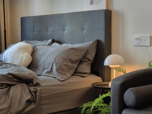 a bedroom with a bed with a large headboard at Central Park Cozy Garden View Studio for 3 pax in Johor Bahru