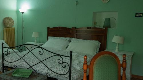 a bedroom with a bed and two tables with lamps at B&B La finestra sul bosco in Serralunga di Crea