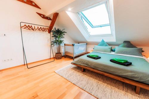 a bedroom with a large bed and a window at Spacious Penthouse with AC and Free Parking Steps Away From the Central Station in Koblenz