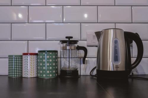 a kitchen counter with a coffee pot and affeepot at The Stable- Hopewell in Bristol