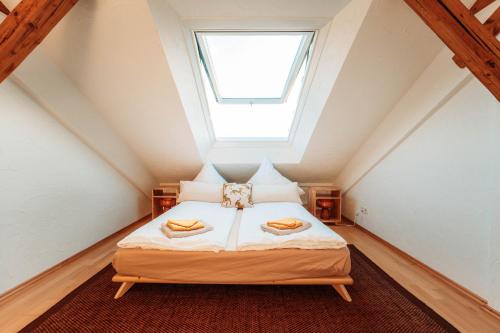 a bedroom with a bed with two towels on it at Spacious Penthouse with AC and Free Parking Steps Away From the Central Station in Koblenz
