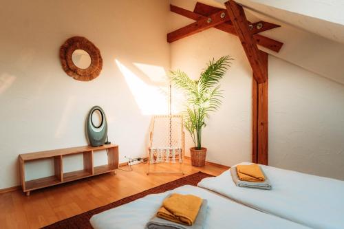 a bedroom with two beds and a mirror and a table at Spacious Penthouse with AC and Free Parking Steps Away From the Central Station in Koblenz