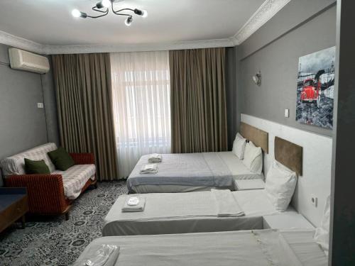 A bed or beds in a room at Mara Suite Taxim