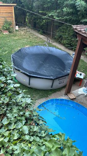 a trampoline sitting on the grass next to a table at B&b Romani in Bologna