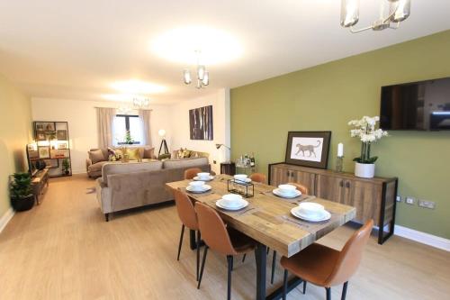 a living room with a wooden table and chairs at Cabot Mews Apartment 8 in Bristol