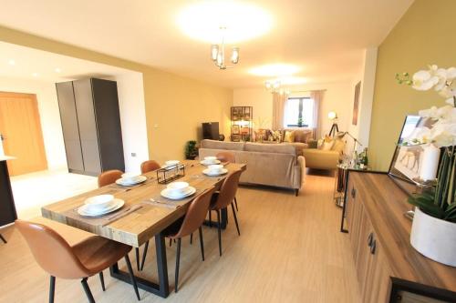 a living room with a wooden table and chairs at Cabot Mews Apartment 8 in Bristol