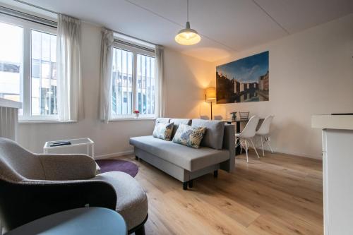 a living room with a couch and a table at Aparthotel North Spacious Suite for 6 Guests in Amsterdam