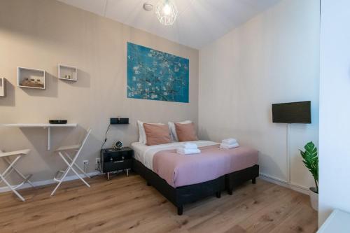 a bedroom with a bed and a desk in it at Aparthotel North Studio With Patio For 2 in Amsterdam