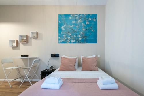 a bedroom with a bed with two towels on it at Aparthotel North Studio With Patio For 2 in Amsterdam