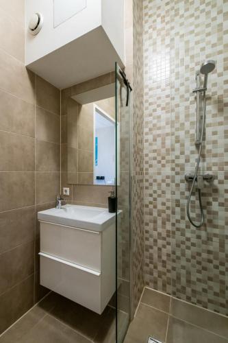 a bathroom with a sink and a shower at Aparthotel North Studio With Patio For 2 in Amsterdam