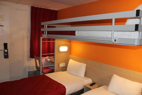a small room with two bunk beds in it at Premiere Classe St Quentin en Yvelines Elancourt in Trappes