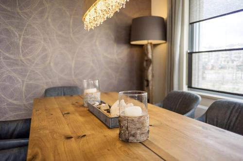 a wooden table with candles and a lamp on it at Portobello in Heiligenhafen