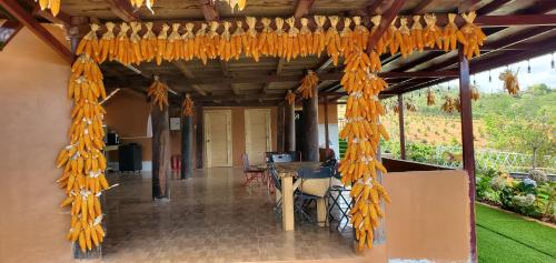 a covered porch with a bunch of orange strings at Thông Reo Farm & Homestay in Lam Ha