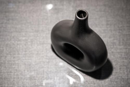 a black vase sitting on top of a table at Alhena Pavilion in Bouzéïka