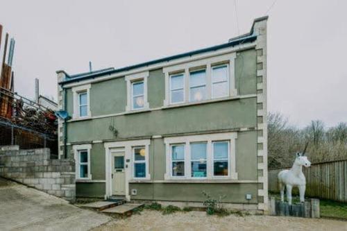 a house with a statue of a goat in front of it at The unicorn's house sleeps 10 people in Bristol