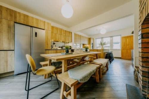 a kitchen with a table and chairs and a refrigerator at The unicorn's house sleeps 10 people in Bristol