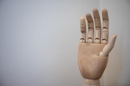 a wooden glove with five pairs of shoes on it at Alhena Pavilion in Bouzéïka