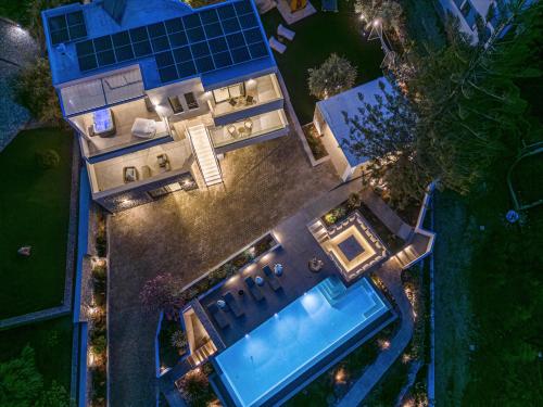 an overhead view of a house with a swimming pool at Alhena Pavilion in Bouzéïka