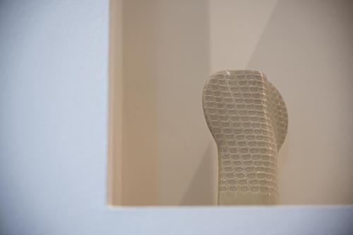 aulpture of a statue is in a mirror at Alhena Pavilion in Bouzéïka