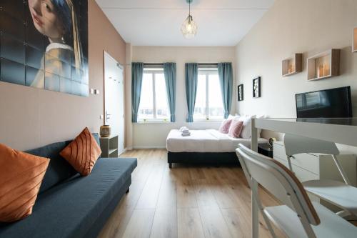 a living room with a couch and a bed at Aparthotel North Spacious Studio for two in Amsterdam