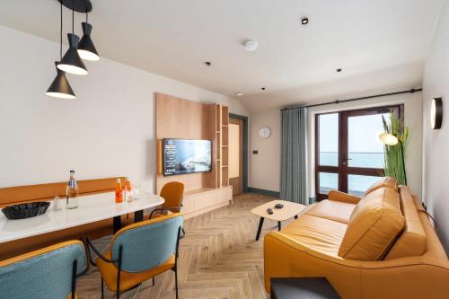 a living room with a couch and a table at Gold Coast Resort Dungarvan in Dungarvan