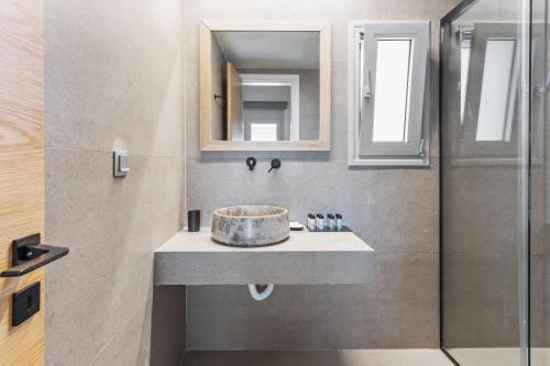 a bathroom with a sink and a shower at blue symphony suites and apartments in Nikiana
