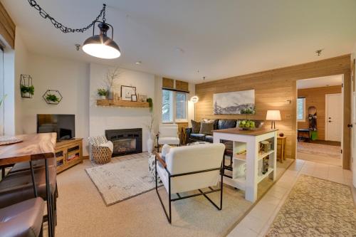 a living room with a fireplace and a dining room at Ski-InandSki-Out Boyne Mountain Resort Rental! in Boyne Falls