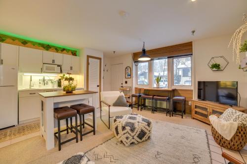 a kitchen and living room with a table and chairs at Ski-InandSki-Out Boyne Mountain Resort Rental! in Boyne Falls